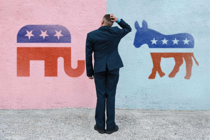 2202832513 Man deciding between elephant and donkey symbols