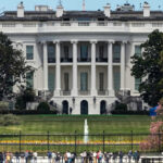 The White House with tourists in the foreground.