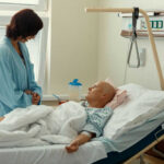 Hospital patient in bed with a visitor watching