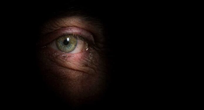 Close-up of a human eye with a dark background
