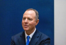 Man in suit with blue tie smiling