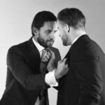 Two men in suits engaged in a tense confrontation