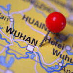 Wuhan Researcher Caught Smuggling Biohazard – Shocking Details! A close-up of a map with a red pin marking the city of Wuhan