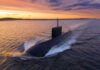 A submarine navigating through the ocean during sunset