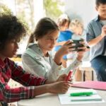 Children engaged in a group activity with electronic devices