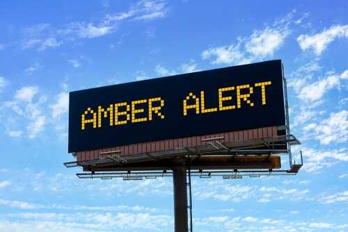 shutterstock_2350070855.jpg Billboard displaying an Amber Alert message against a blue sky
