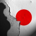 Silhouette of a pregnant woman against a textured wall with a red circle