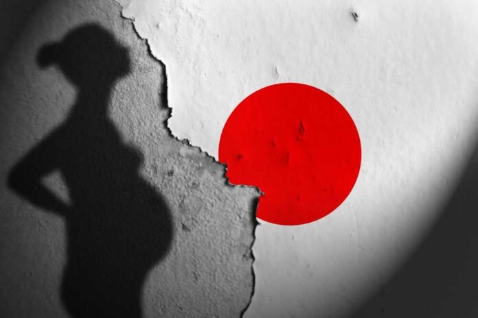 Silhouette of a pregnant woman against a textured wall with a red circle