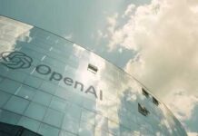 Exterior view of the OpenAI building with a reflective glass facade under a cloudy sky