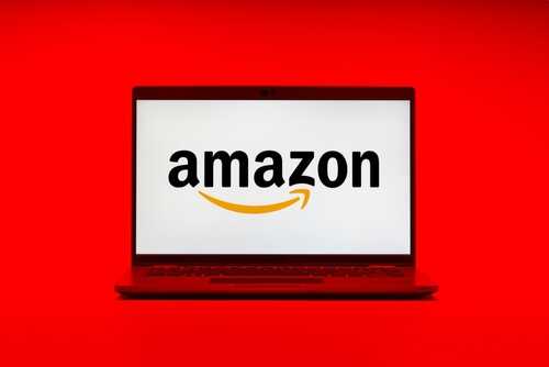 Laptop displaying the Amazon logo on a red background