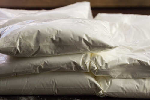 Stack of white packaged flour bags