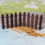 Trump’s Bold Border Move Shocks Nation A small wooden fence placed on a map of Mexico