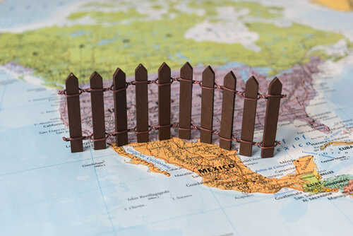 A small wooden fence placed on a map of Mexico