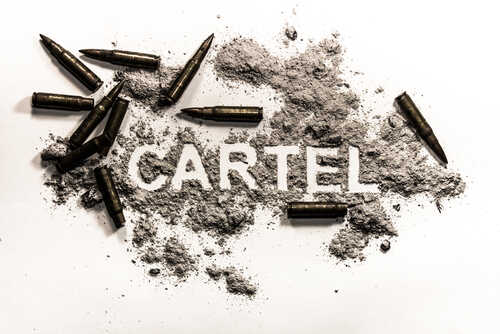 shutterstock_747572428.jpg The word 'CARTEL' formed with gunpowder and surrounded by bullets
