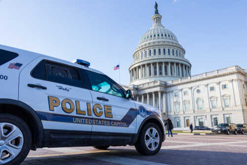 Police vehicle parked in front of the United States Capitol building