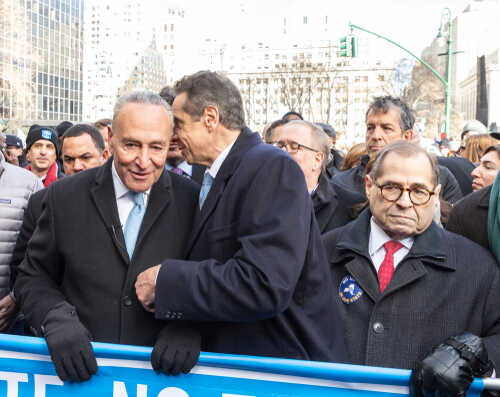 Politicians engaging in conversation at a public rally