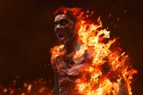 A person engulfed in flames, expressing intense emotion