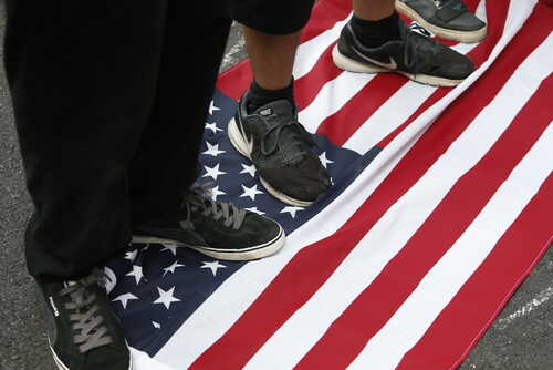 Feet standing on an American flag