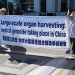 Activists holding a banner about organ harvesting in China