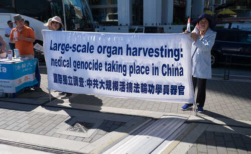 Activists holding a banner about organ harvesting in China