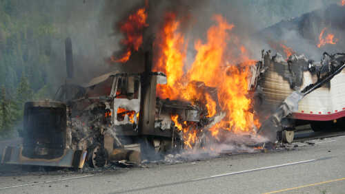 Burning truck on the highway with flames and smoke