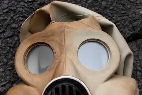 shutterstock_2202365211.jpg Close-up of a vintage gas mask with round lenses and a rubber exterior