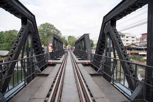 A railway bridge with tourists walking on it