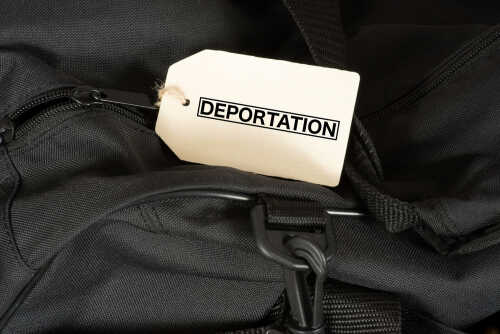 A black bag with a luggage tag labeled 'DEPORTATION'