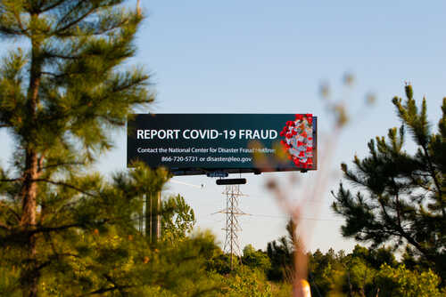 Billboard urging the public to report COVID-19 fraud