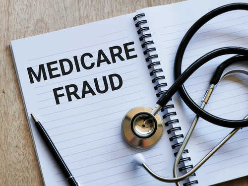 Notebook with the words 'MEDICARE FRAUD' and a stethoscope