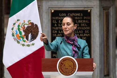 shutterstock_2530931317.jpg A government official delivering a speech in front of the Mexican flag