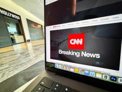 Laptop displaying CNN Breaking News in a shopping mall