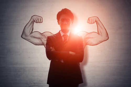 Businessman standing confidently with illustrated muscular arms behind him