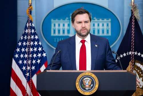 Government official speaking at a podium in the White House press briefing room