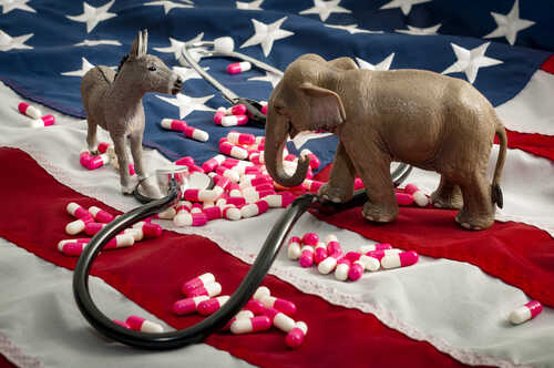 shutterstock_671738629.jpg Animal figurines of a donkey and elephant on an American flag with scattered pills