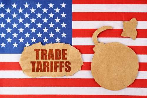 Cardboard cutout of a bomb and the words 'TRADE TARIFFS' on a background of the American flag