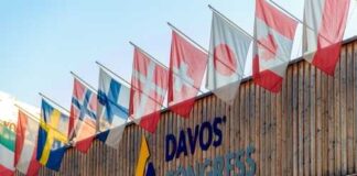 Exterior view of the Davos Congress building with multiple international flags