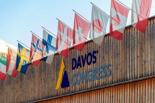 shutterstock_2520294955.jpg Exterior view of the Davos Congress building with multiple international flags