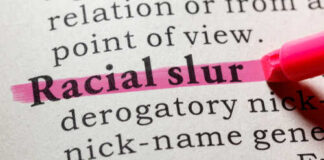 Highlighted definition of 'racial slur' in a dictionary