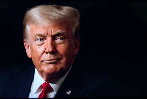 Close-up portrait of a man with a serious expression wearing a suit