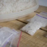 Containers of salt crystals on a wooden surface