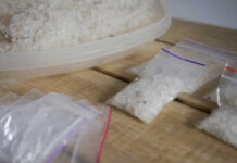 Containers of salt crystals on a wooden surface