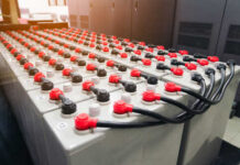 Rows of industrial batteries with red and black terminals