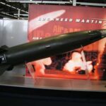 A missile model displayed at a trade show with Lockheed Martin branding