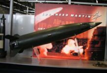 Trump FORCES Weapons Surge — Shareholders Take Backseat A missile model displayed at a trade show with Lockheed Martin branding