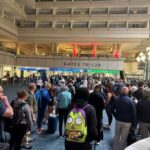 Crowd of travelers waiting in line at an airport terminal