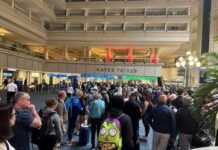 Crowd of travelers waiting in line at an airport terminal