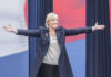 France’s Election Shock: Rule Change Shakes Up Power Game A woman with outstretched arms at a political rally