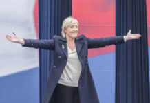 A woman with outstretched arms at a political rally