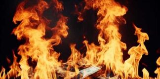 A pile of burning dollar bills engulfed in flames